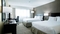 Hilton Nashville Airport - The standard room with two queen beds includes a flat screen TV, free WIFI, mini refrigerator, and coffee maker.