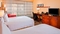 Courtyard Orlando Airport - The standard room with two queen beds includes complimentary WiFi. 