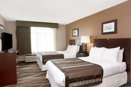 Wingate by Wyndham Raleigh Durham Airport - Guest room with two double beds.